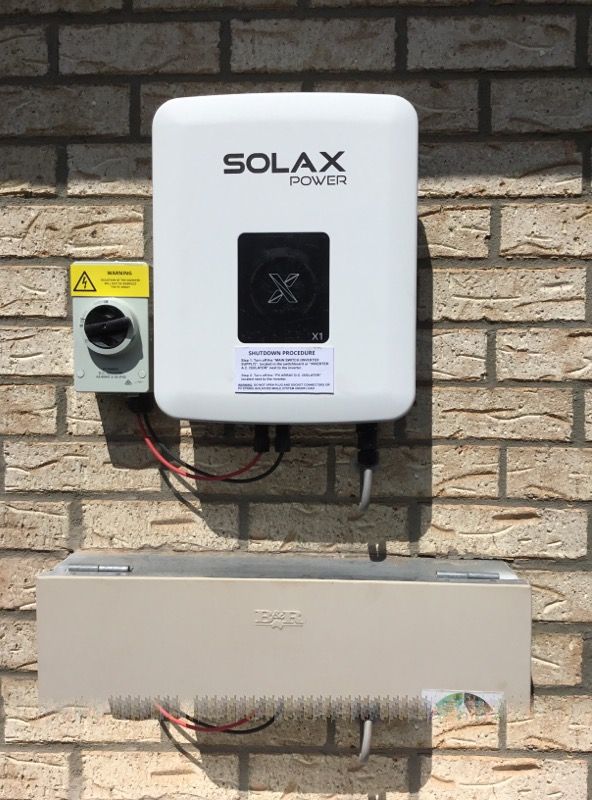 A Solar Inverter is Mounted on a Brick Wall β Sapphire City Solar & Electrical In Inverell, NSW