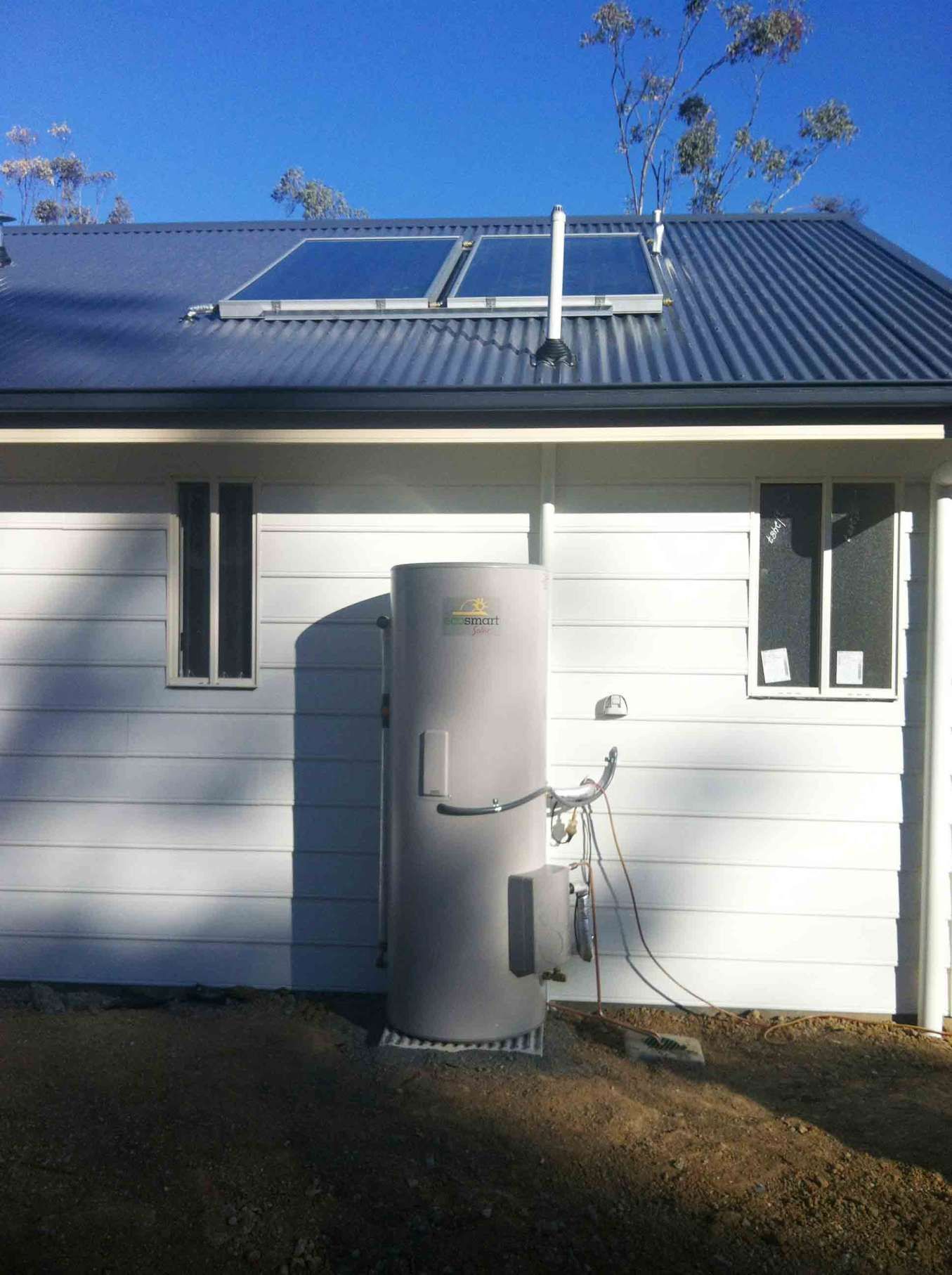 A White House With a Gray Water Heater on the Side β Sapphire City Solar & Electrical In Inverell, NSW
