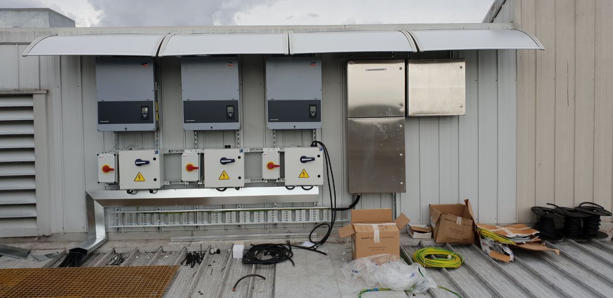 A Row of Electrical Boxes Are Sitting on the Roof of a Building β Sapphire City Solar & Electrical In Inverell, NSW