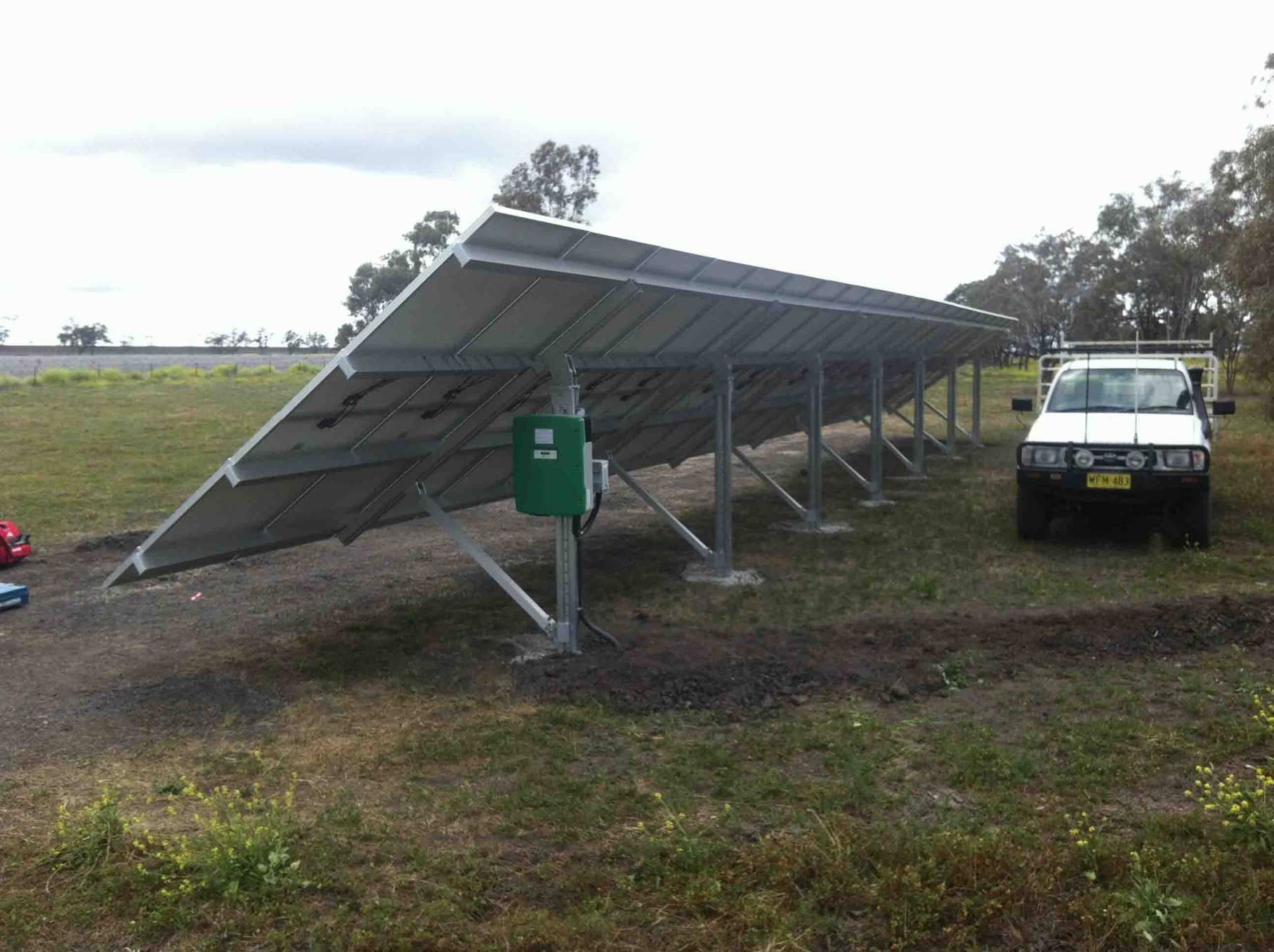 A White Truck is Parked in Front of a Row of Solar Panels β Sapphire City Solar & Electrical In Inverell, NSW