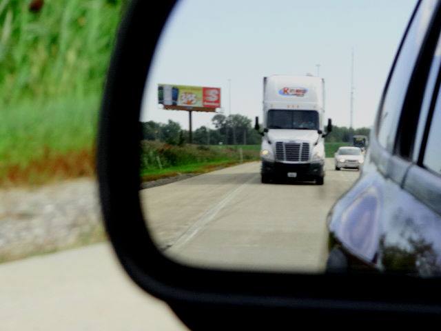 Truck Reflection In Side Mirror — Merrillville, IN — Ray's Movers & Storage Inc.