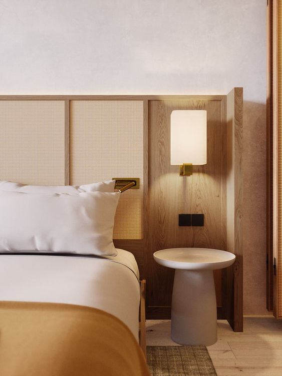 A bedroom with a bed , nightstand and lamp