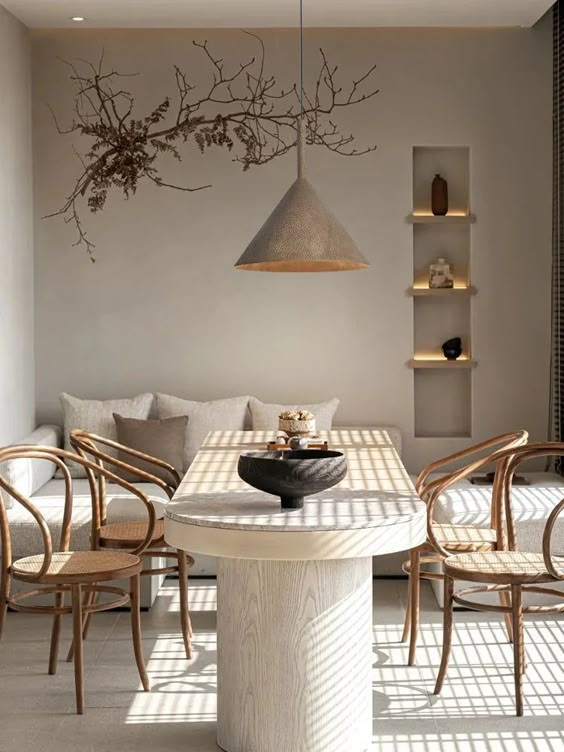 A living room with a table and chairs and a couch.