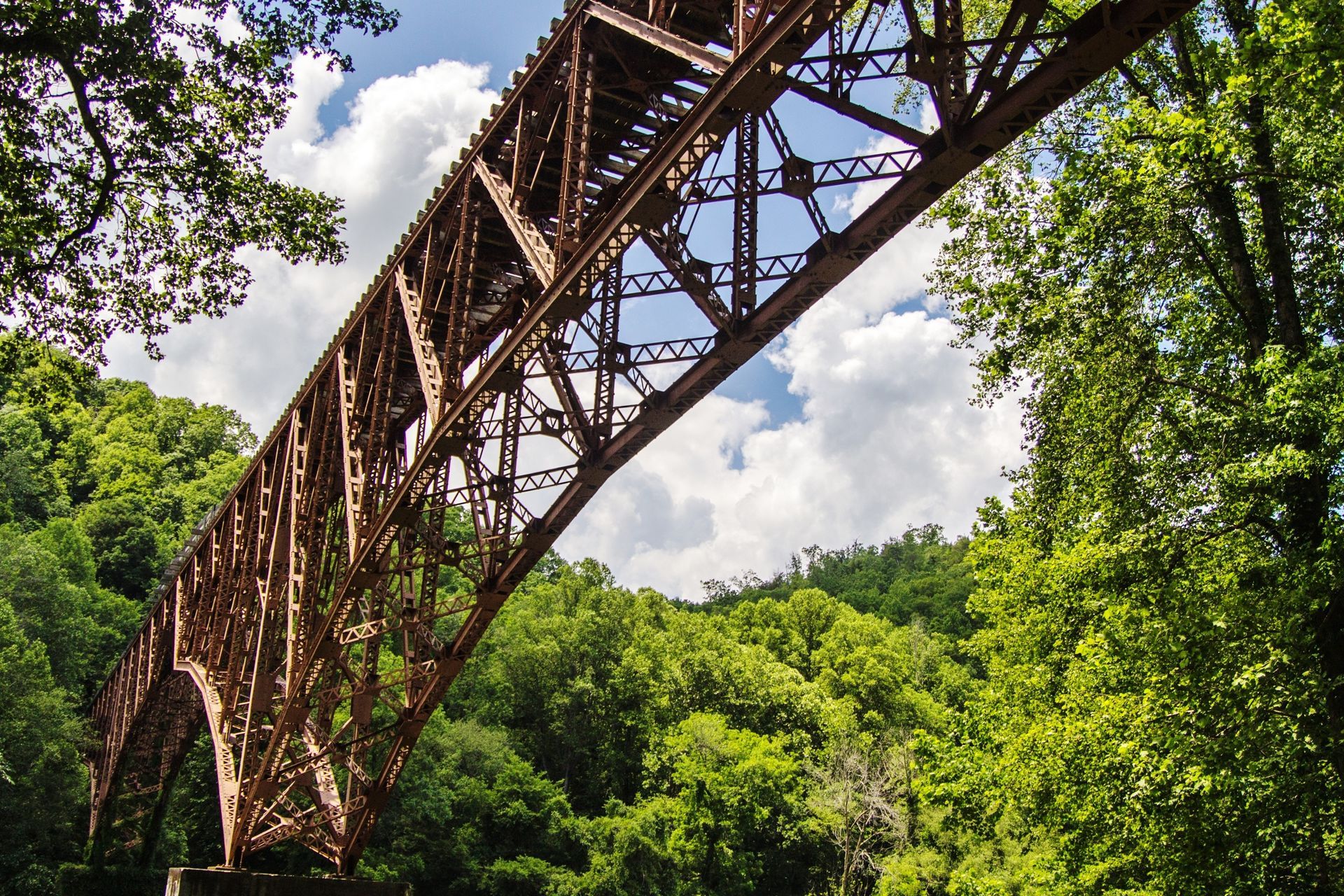 A bridge over a river with trees in the background