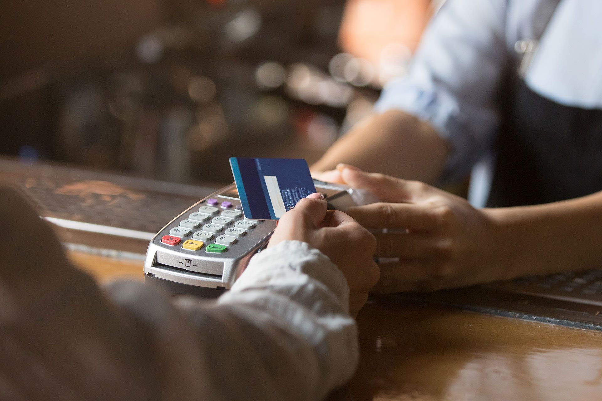A person is paying with a credit card at a restaurant.