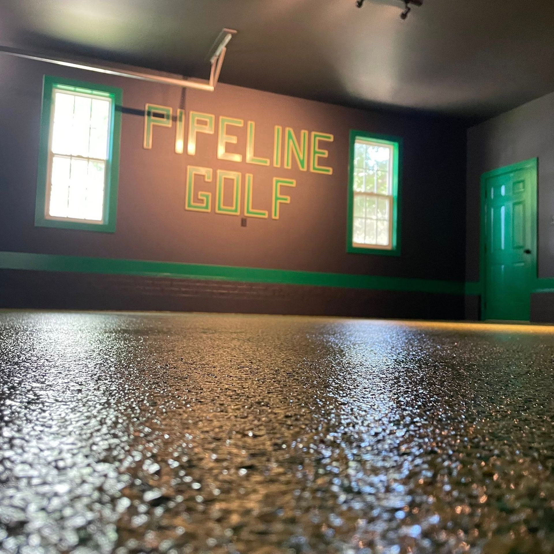 Garage with glossy floor, green trim, 