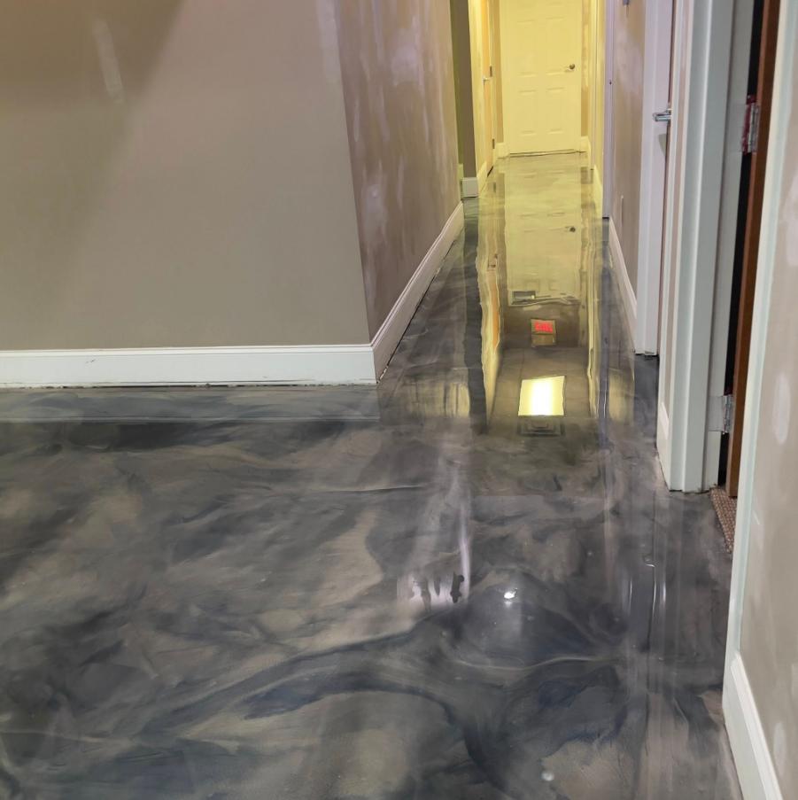 Green epoxy floor in a garage; walls are brick and white.