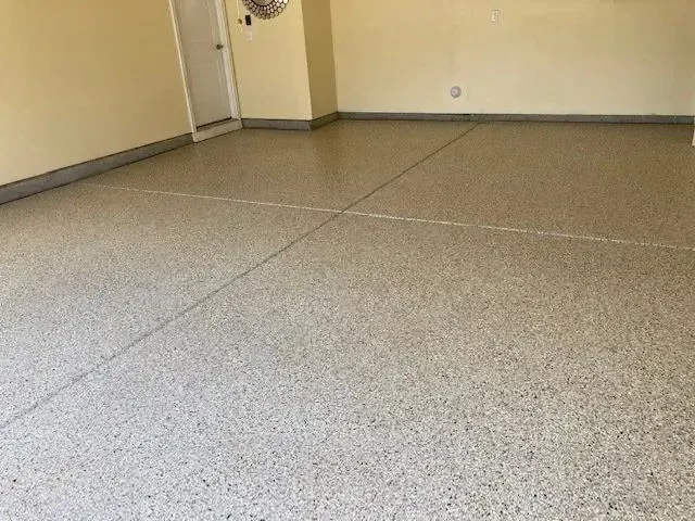Garage with speckled, glossy epoxy floor; beige walls.