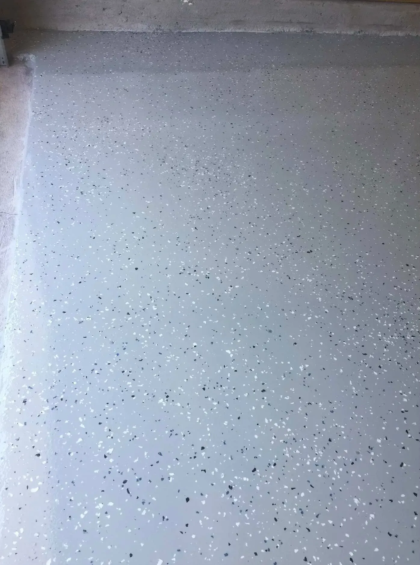Gray garage floor with speckled chips.
