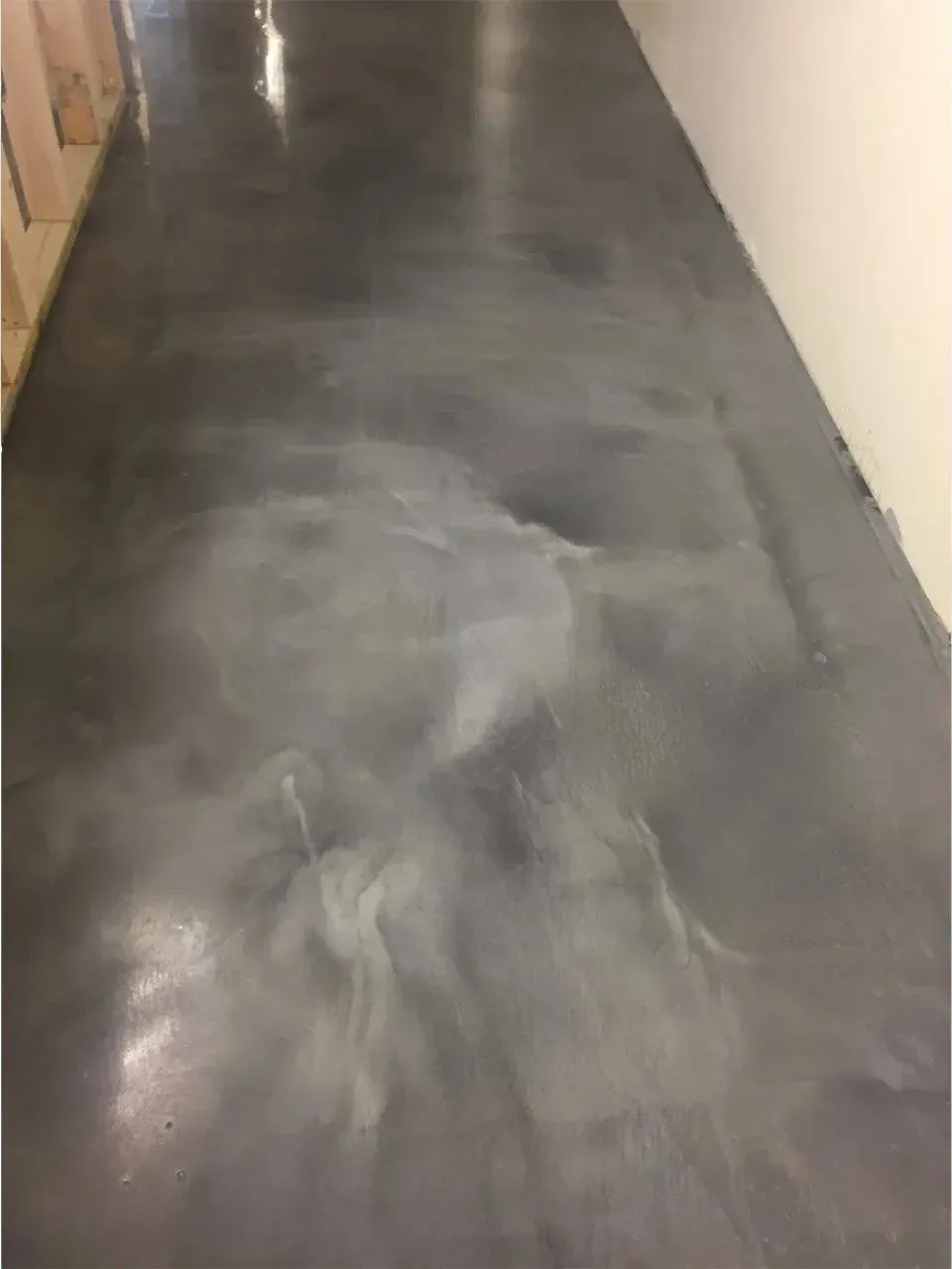 Metallic gray epoxy floor reflecting light.