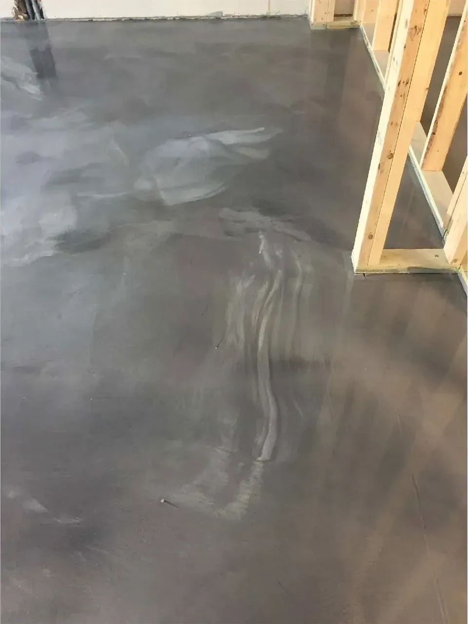 Gray metallic epoxy flooring with wood framing.