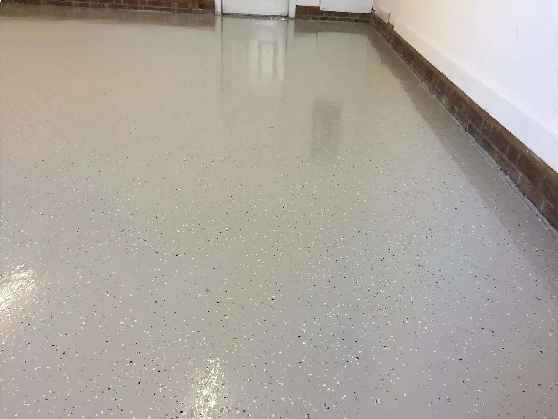 Light gray epoxy garage floor with flecks of color.