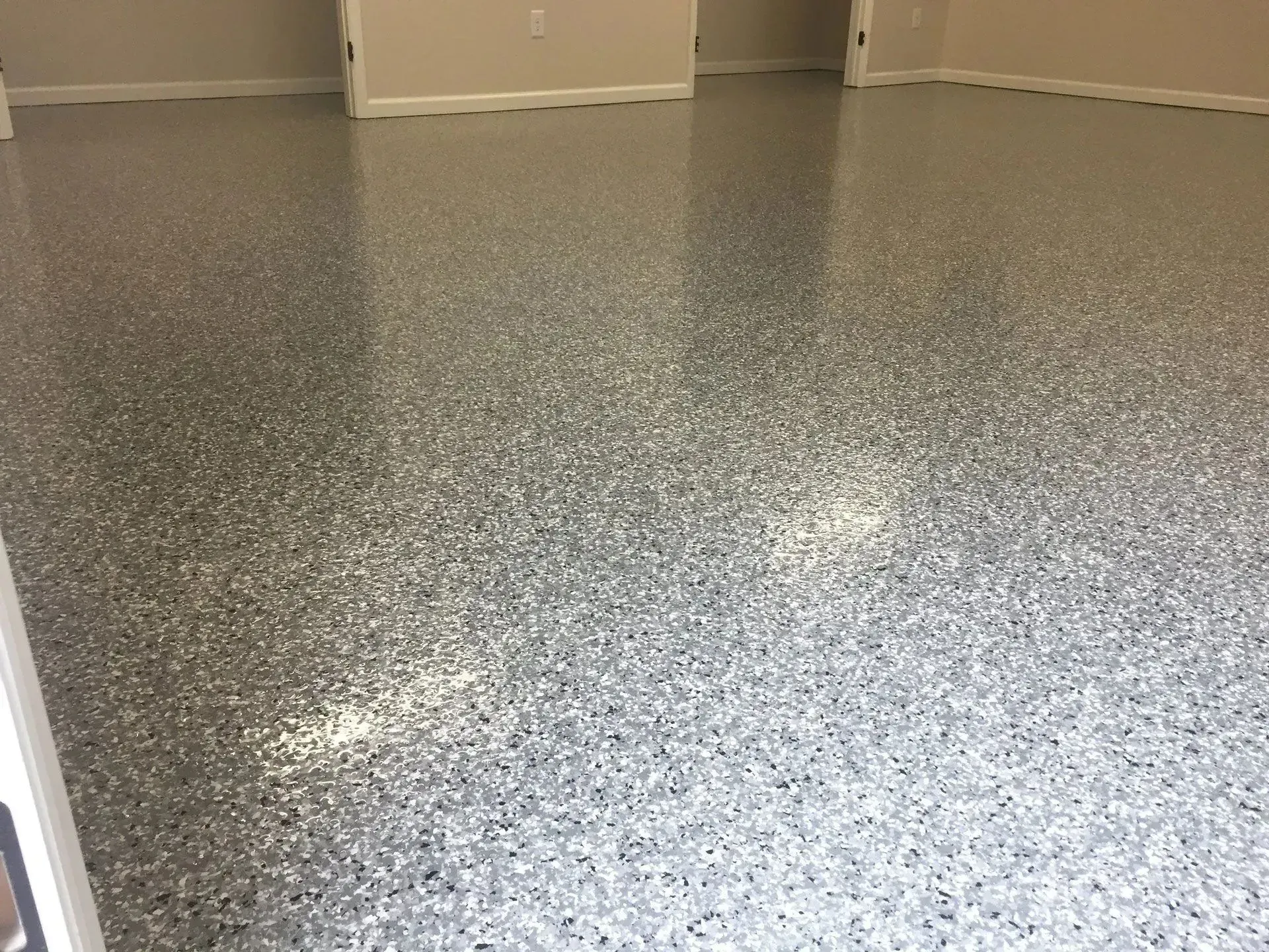Epoxy-coated floor with speckled gray, black, and white chips.