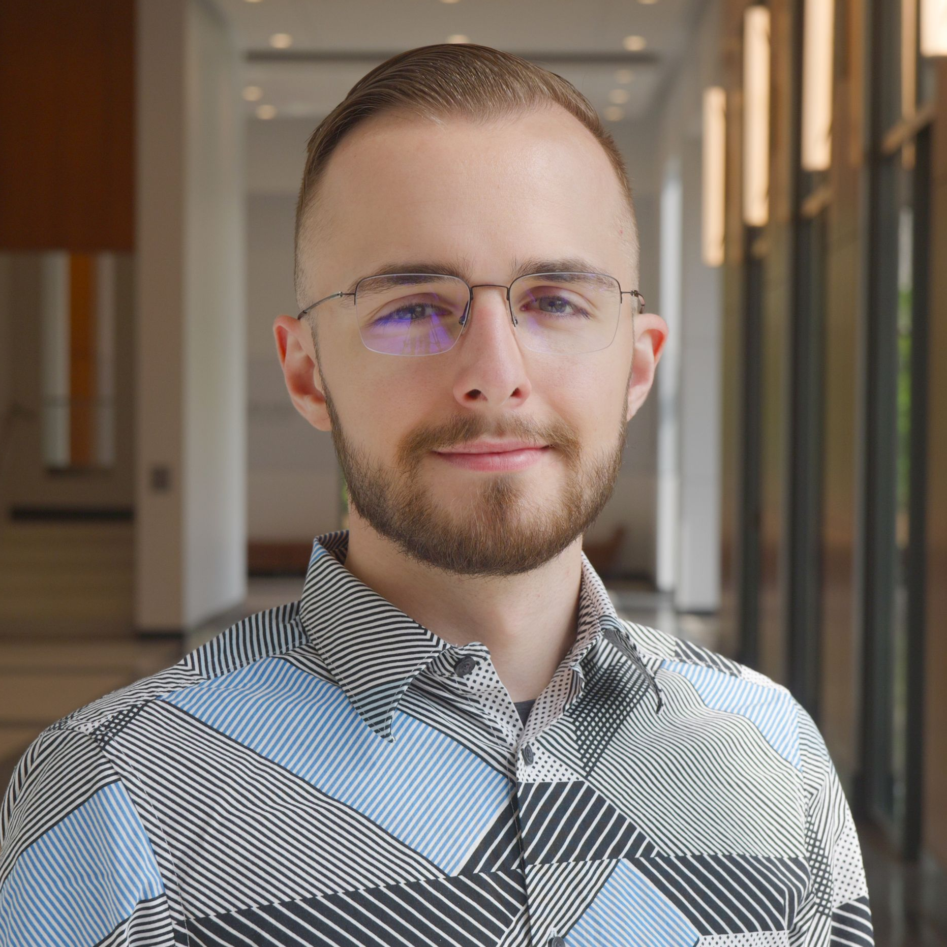 A man wearing glasses and a beard.