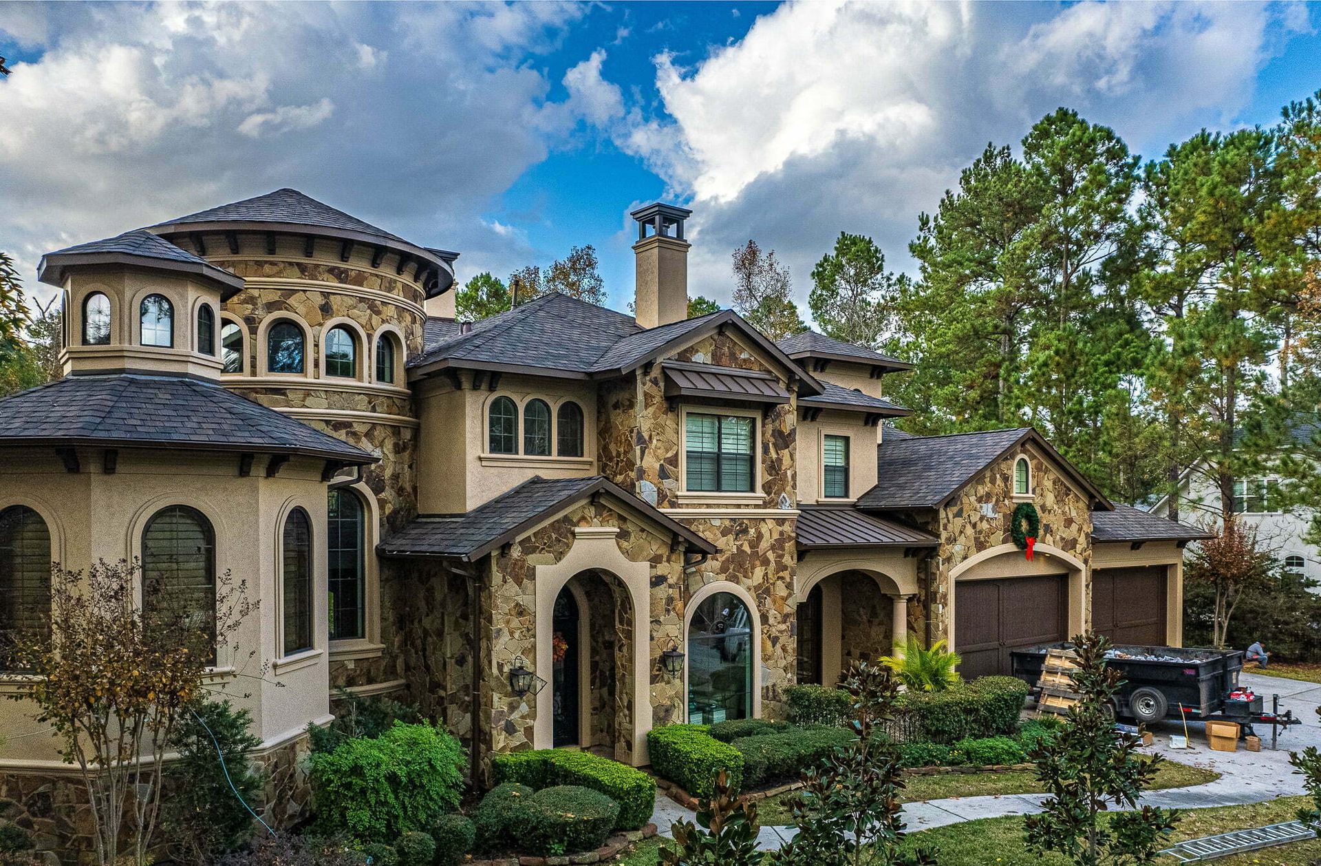 A large house with a black truck parked in front of it.
