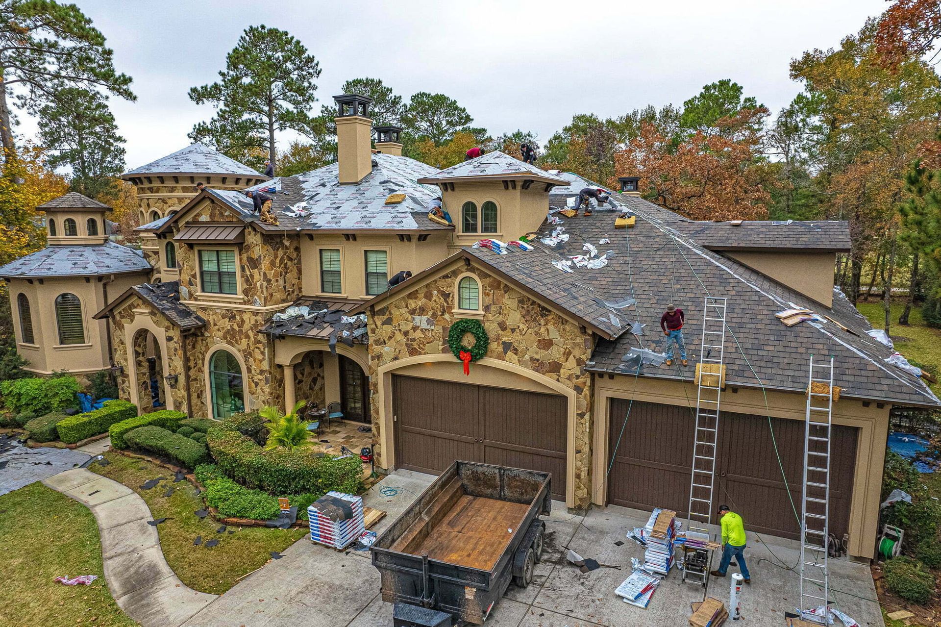 An aerial view of a large house being remodeled.