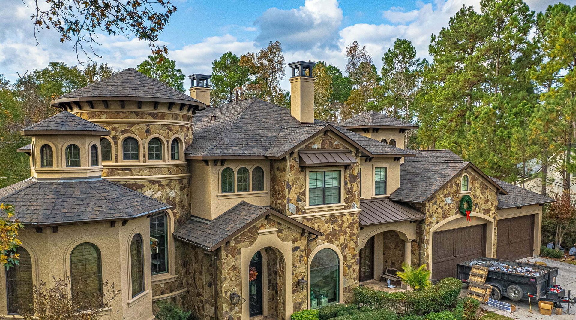 A large house with a trailer parked in front of it.