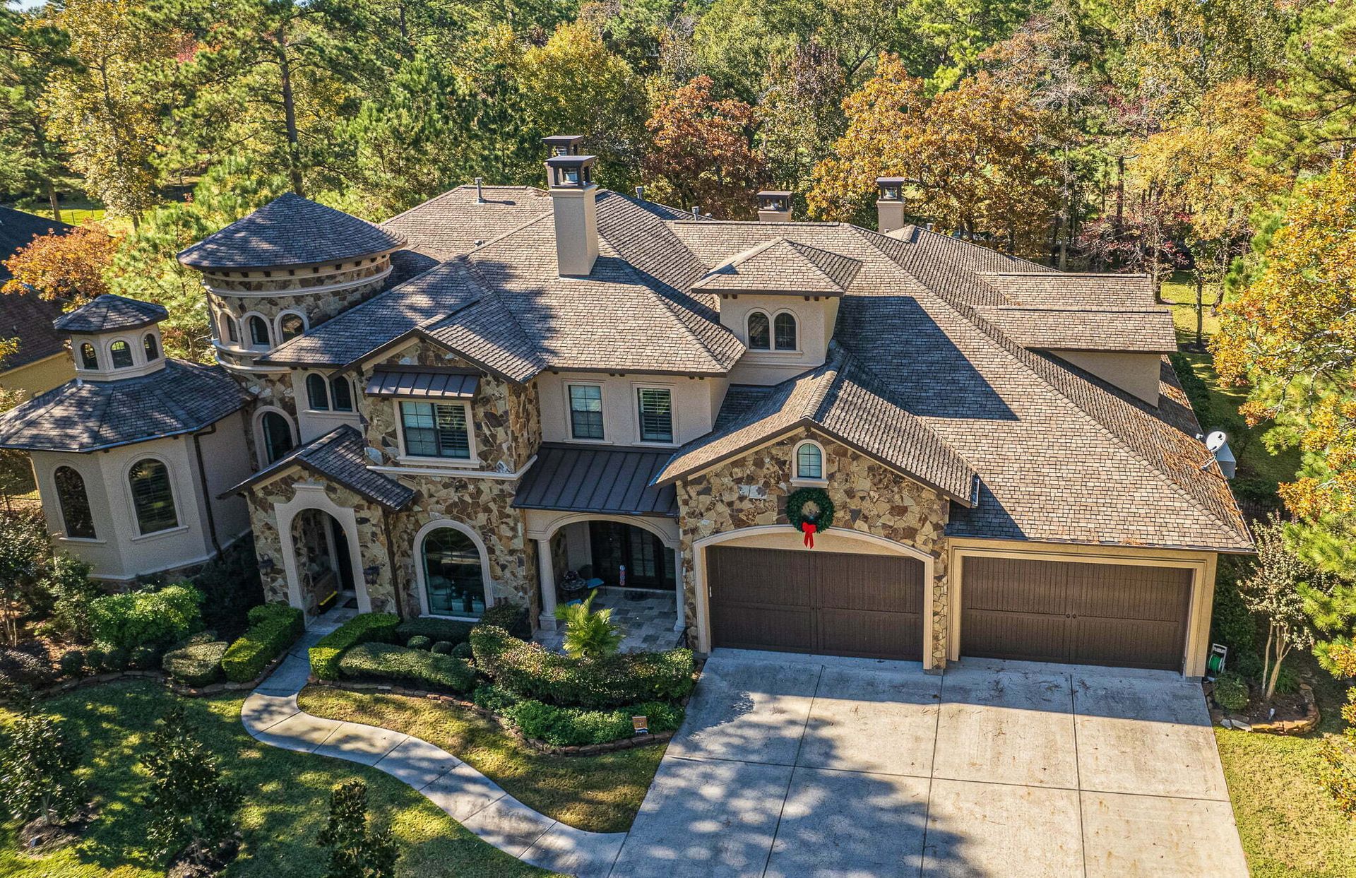 An aerial view of a large house with a wreath on the front door.
