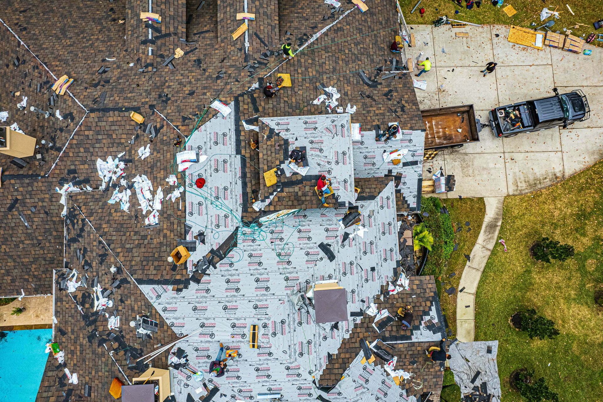An aerial view of a roof being installed on a house.