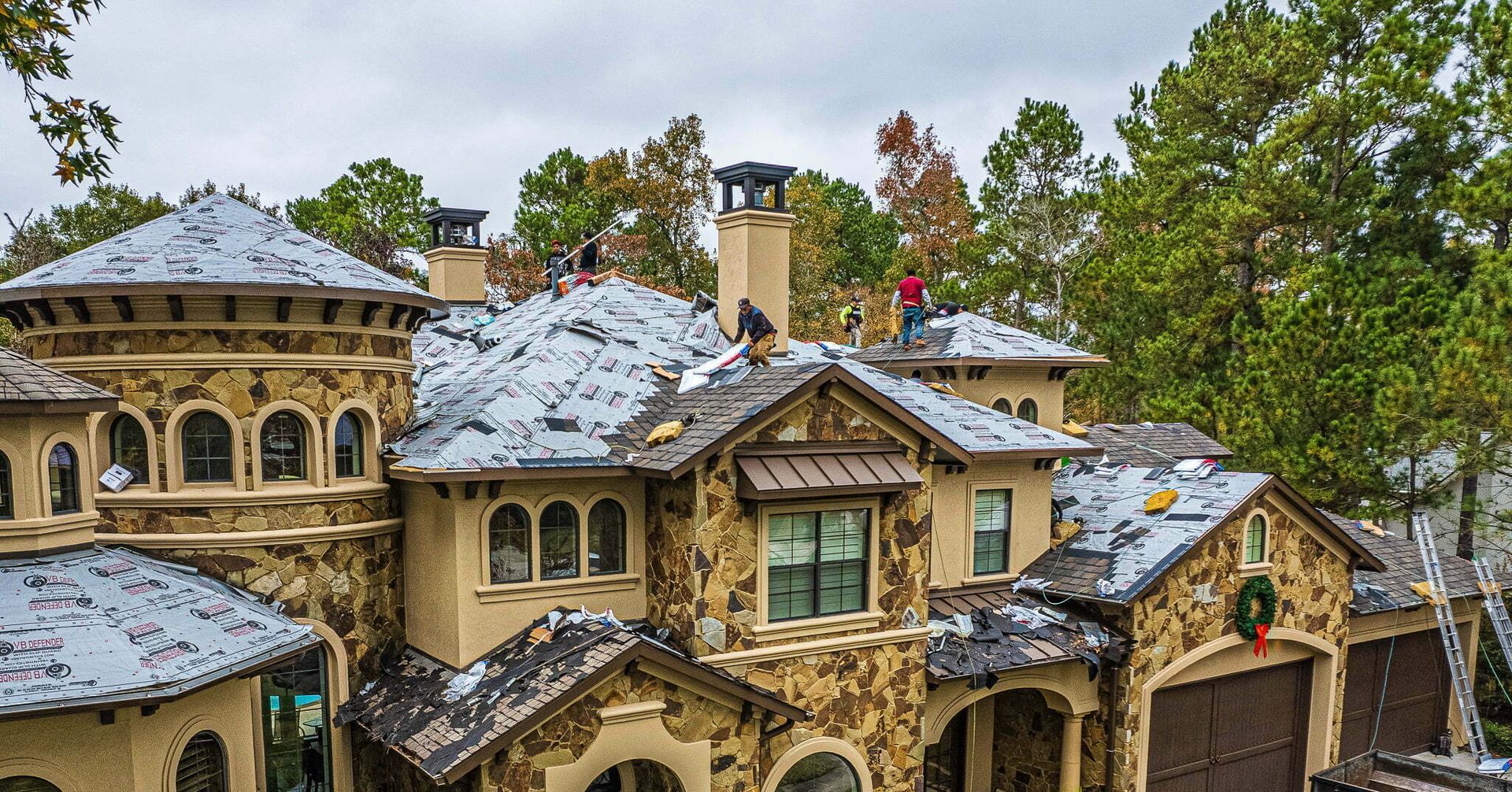 A large house with a lot of snow on the roof.