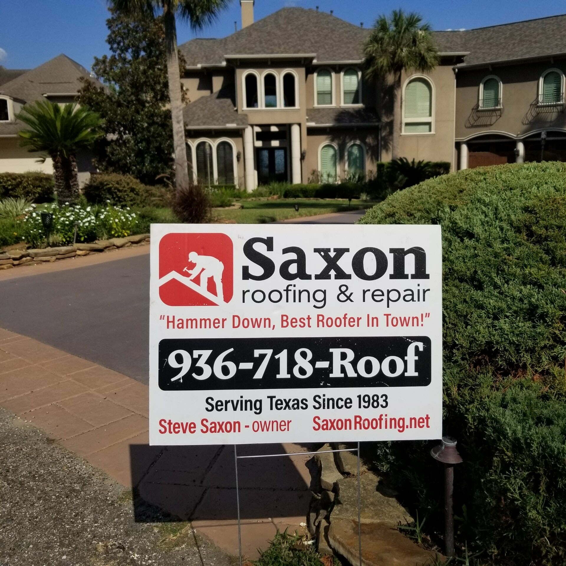 A saxon roofing and repair sign in front of a house