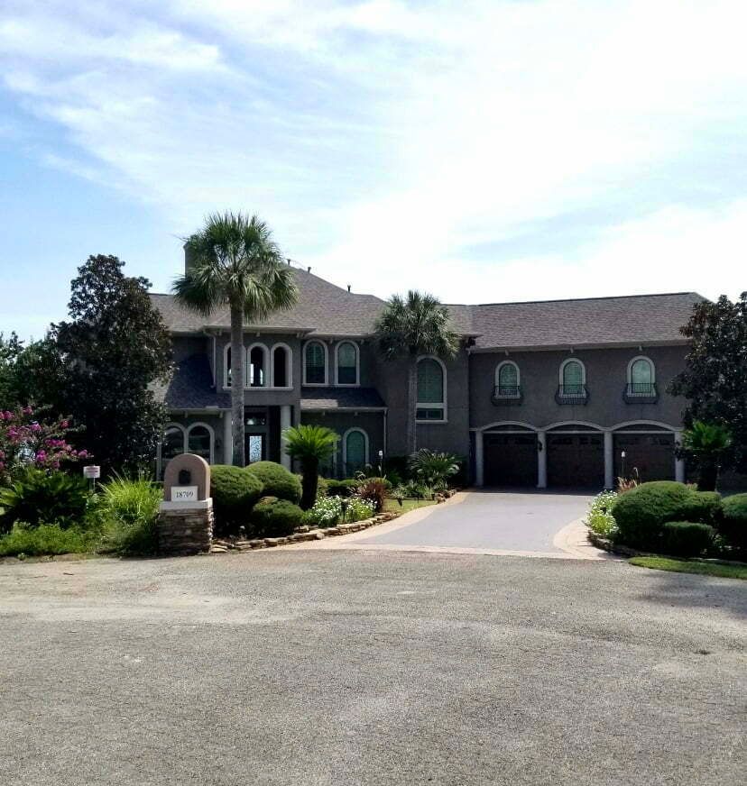 A large house with a palm tree in front of it