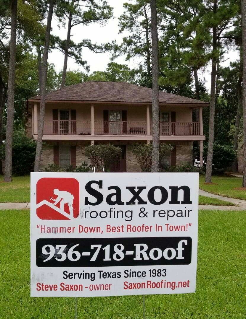 A saxon roofing and repair sign in front of a house