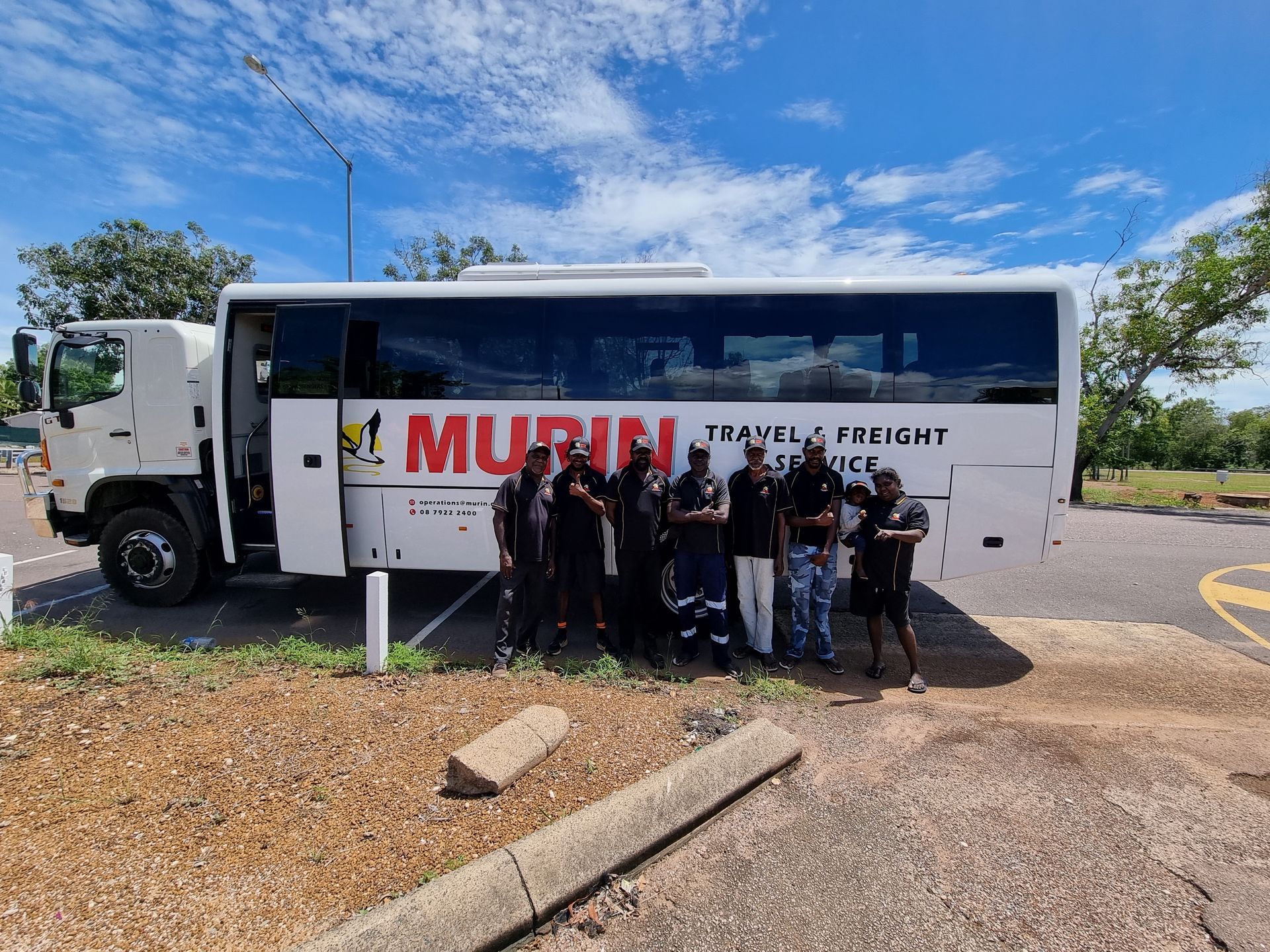 People standing next to a white truck with 