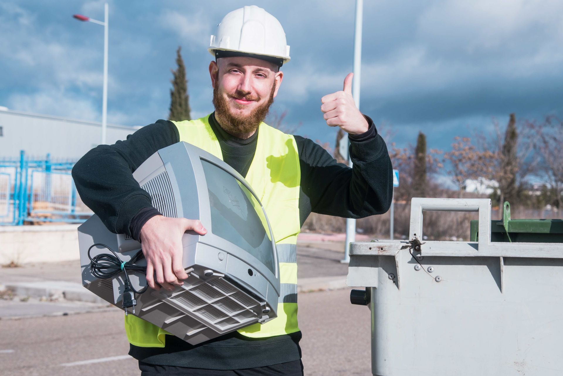 Man holding an old T.V. doing thumbs up gesture