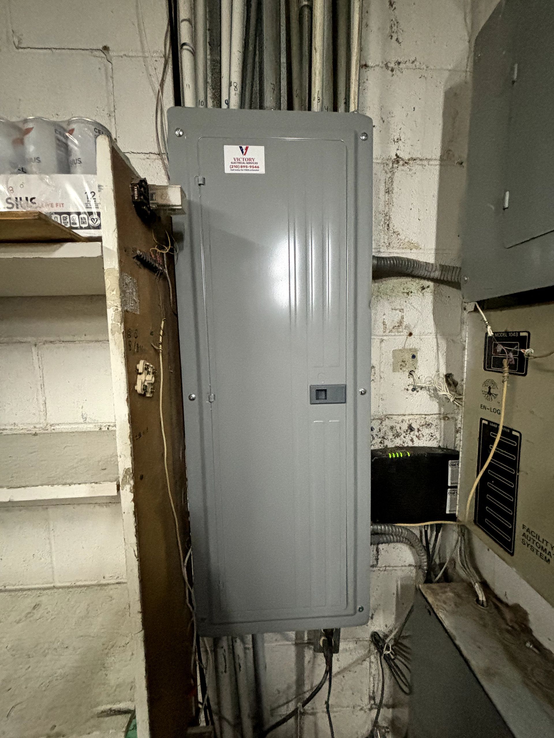 A gray electrical box is hanging on a wall in a room.