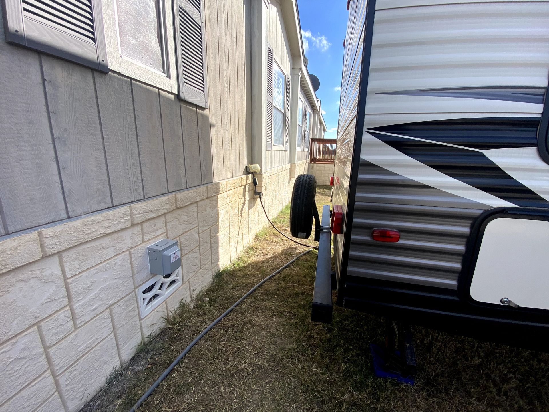 A trailer is parked next to a mobile home.