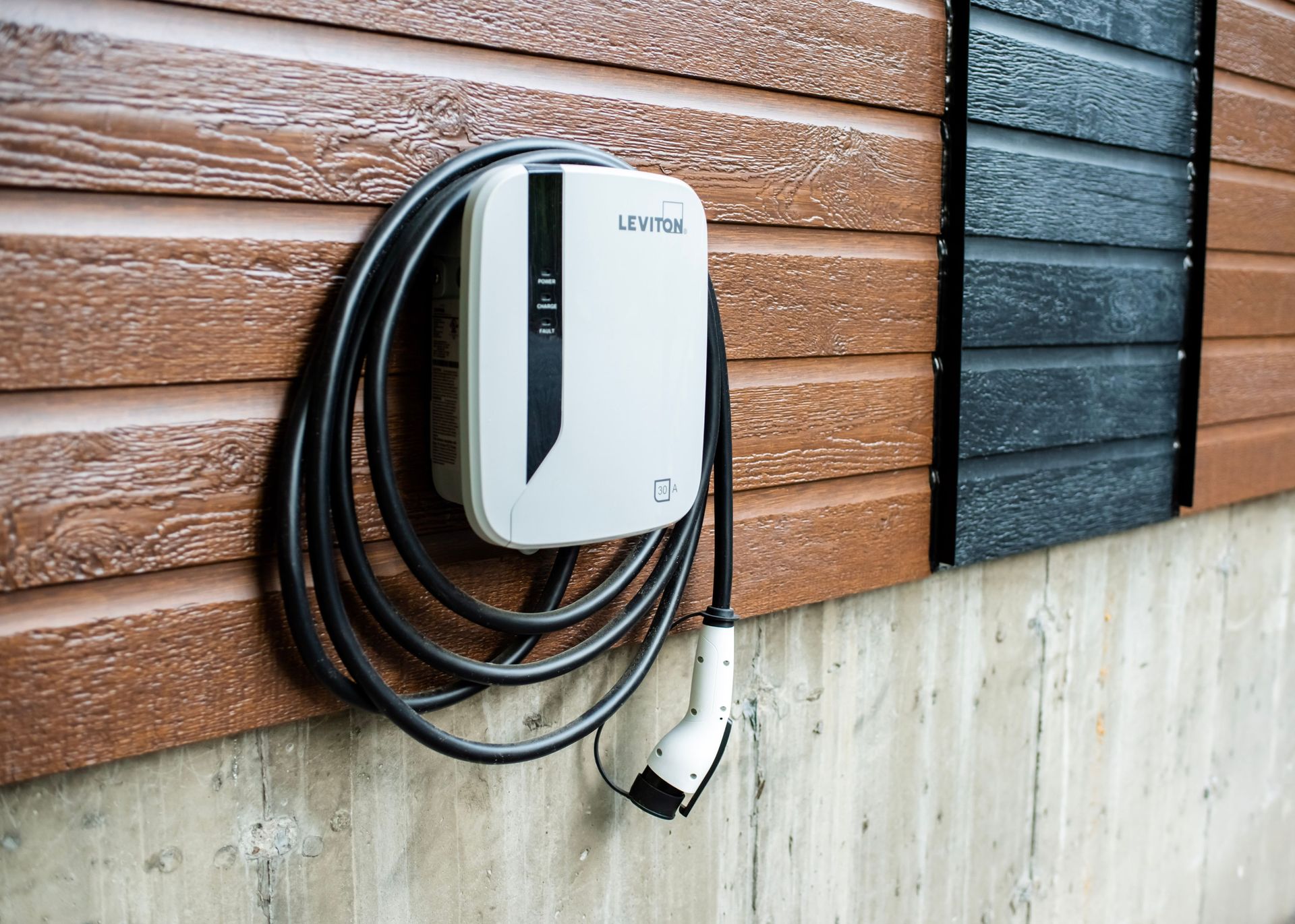 A charger is attached to the side of a building.