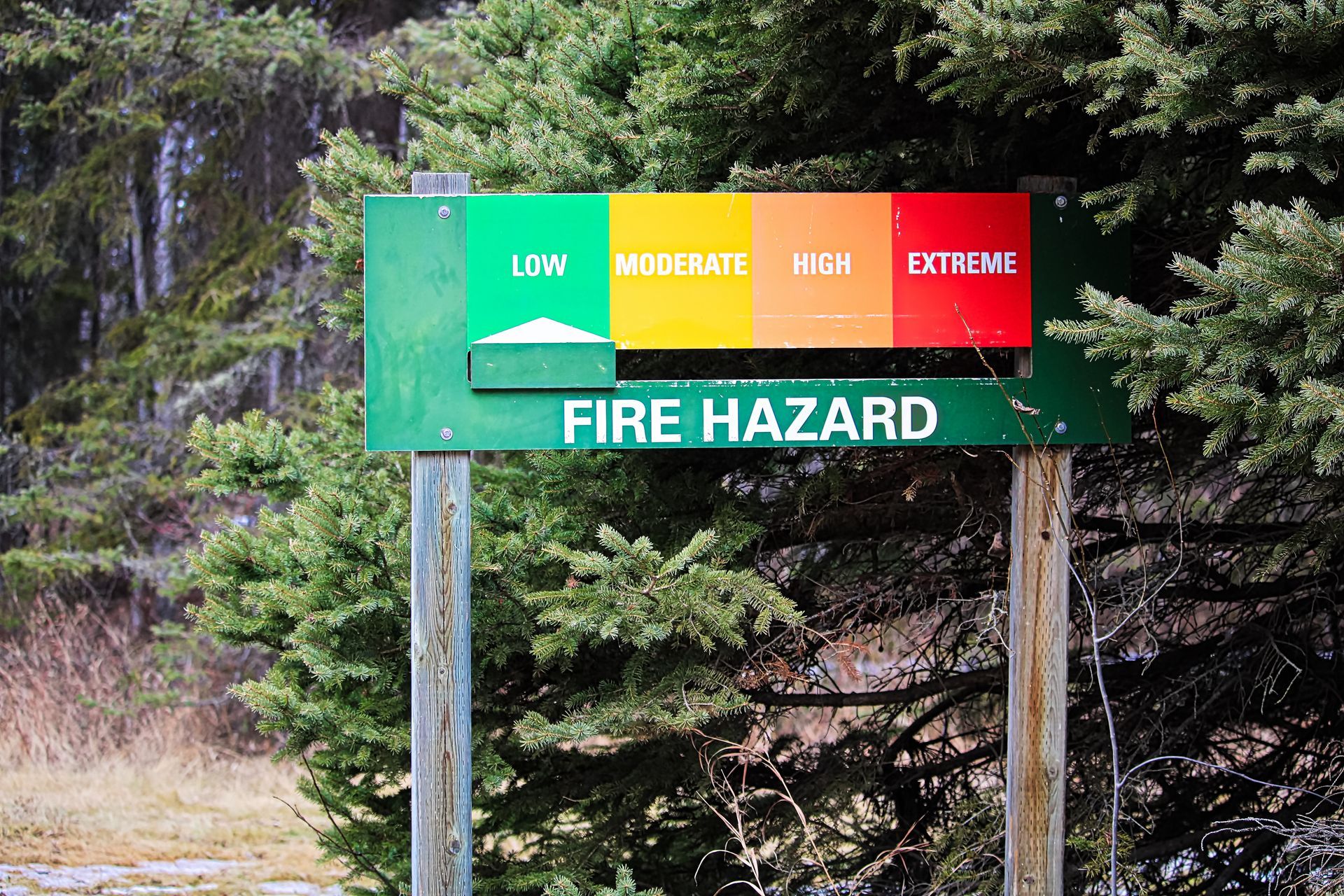 Campground sign displaying 'Low Fire Risk' message with green background and white text.