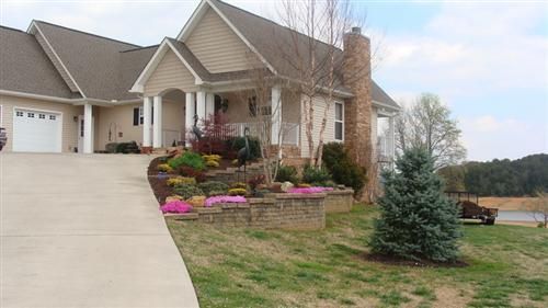 A large house with a driveway leading to it