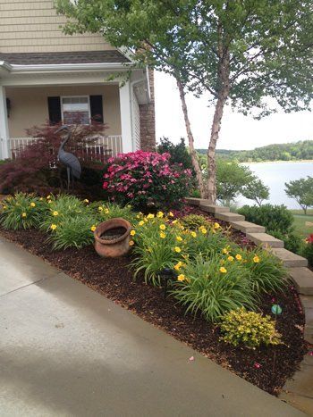 A house with a lot of flowers in front of it