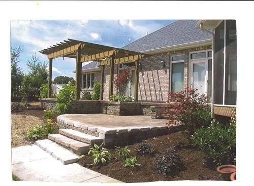 A picture of a house with a pergola and steps