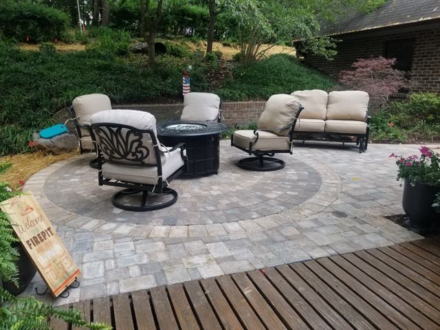 There is a fire pit in the middle of the patio.