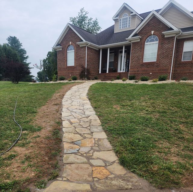 A brick house with a stone walkway leading to it