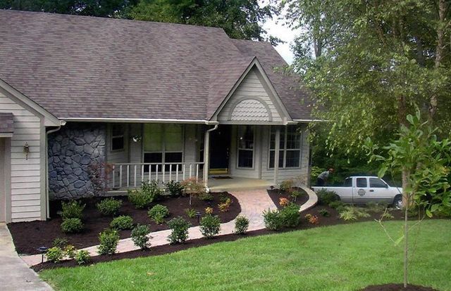 A white truck is parked in front of a house