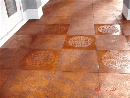 Brown and tan stained concrete floor with Celtic knot designs, near a white doorway.