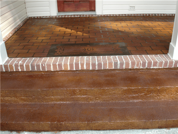 Brick porch with steps, stained brown.