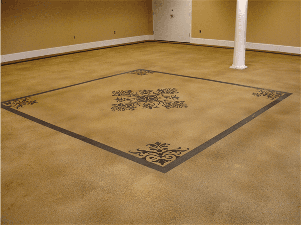 Tan concrete floor with a gray decorative square border and floral center design.