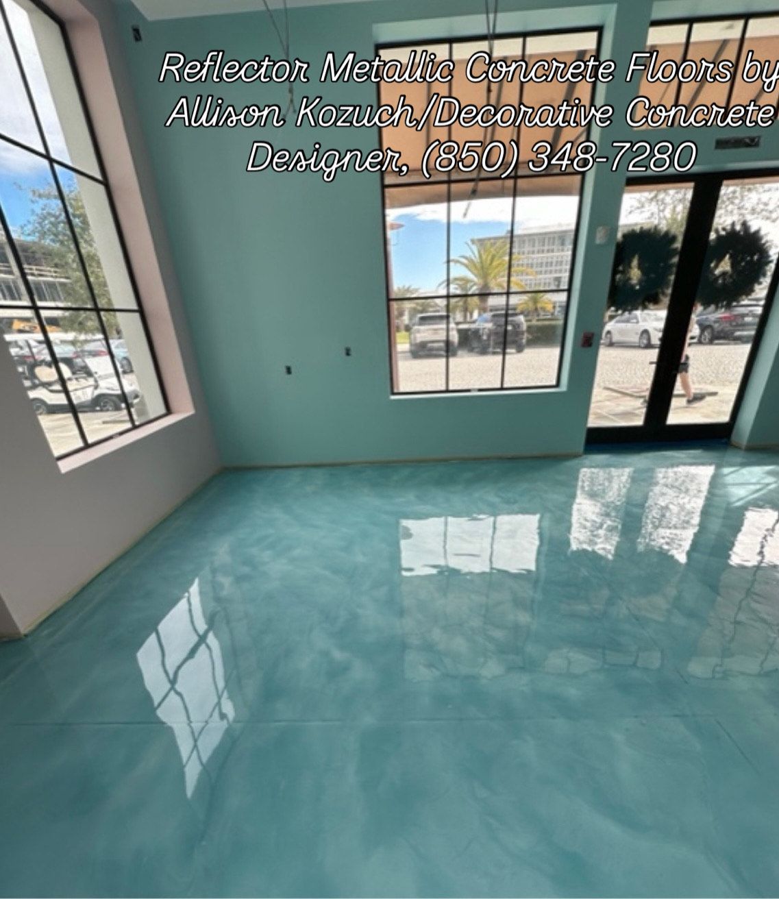 Blue metallic epoxy floor in a room with large windows, near an entry door.