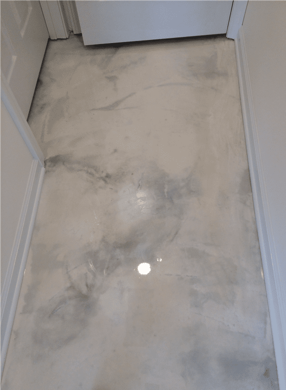 Gray and white epoxy floor in a doorway, with marble-like swirling patterns.
