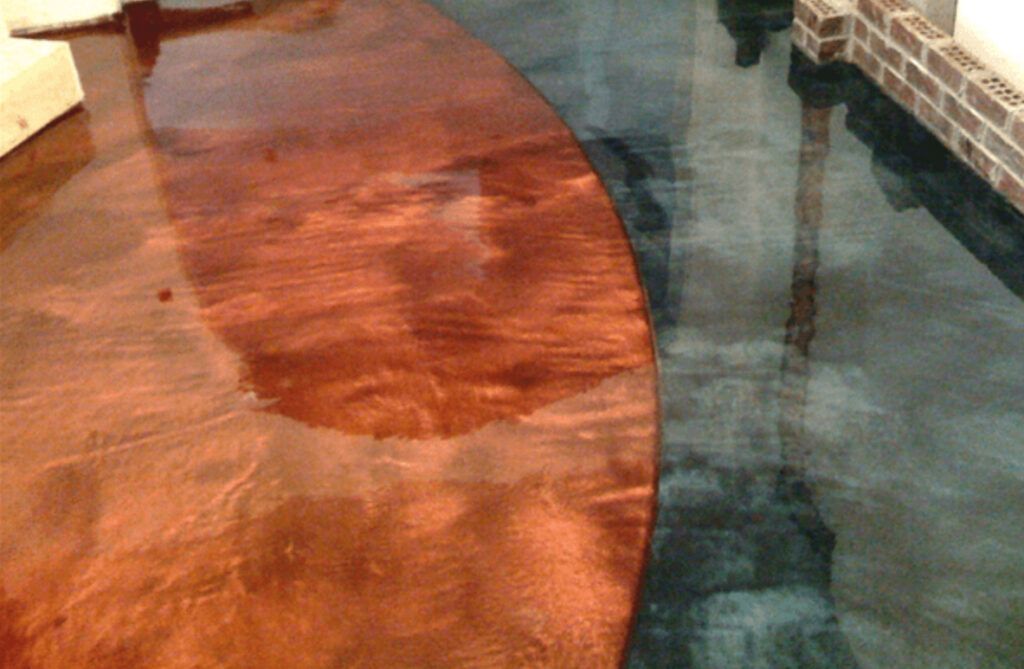 Metallic epoxy floor, copper-brown and teal-blue, with a curved divide.