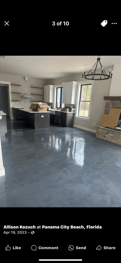 Modern kitchen with polished concrete floors and a stone fireplace.