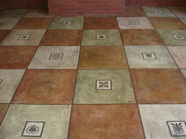 Square tiled floor in shades of brown, green, and cream with decorative center squares.
