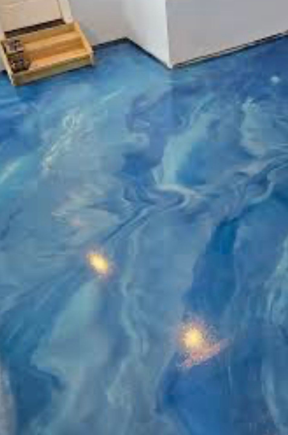 Blue metallic epoxy floor with swirling patterns.