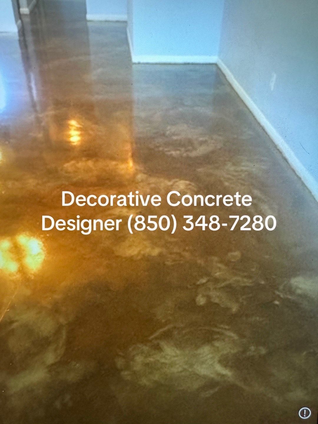 Metallic gold decorative concrete floor with contact info.