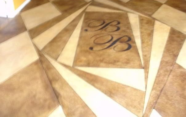 Decorative concrete floor with a custom geometric design and initials BB.